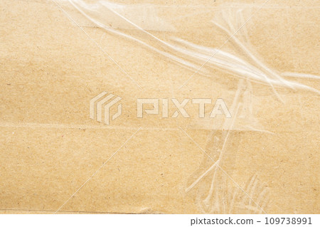 transparent adhesive tape on old brown cardboard paper background 109738991