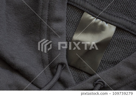 Blank black laundry care clothes label on black fabric texture background Blank black laundry care clothes label on black fabric texture background 109739279