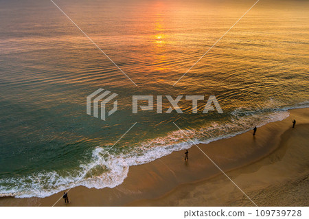 It s sunny morning fisherman is catching fish on ocean during sunrise It s sunny morning fisherman is catching fish on ocean during sunrise 109739728
