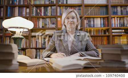 Portrait of a senior woman librarian working late, occupation, scientific research Portrait of a senior woman librarian working late, occupation, scientific research 109740400