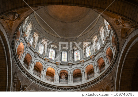 Paris, France, July 1 2022. Fascinating photo of the interior of the dome of the Sacre Coeur Basilica. The scene is illuminated by the natural light that filters through the windows. Paris, France, July 1 2022. Fascinating photo of the interior of the dome of the Sacre Coeur Basilica. The scene is illuminated by the natural light that filters through the windows. 109740793