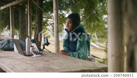 Teenager uses laptop and phone to creating content for viewers Teenager uses laptop and phone to creating content for viewers 109740931