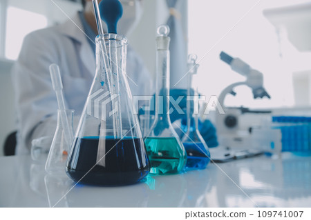 biochemical research scientist team working with microscope for coronavirus vaccine development in pharmaceutical research labolatory, selective focus biochemical research scientist team working with microscope for coronavirus vaccine development in pharmaceutical research labolatory, selective focus 109741007