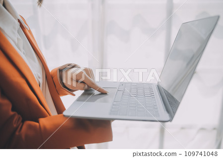 Portrait of Young Asian woman hand freelancer is working her job on computer tablet in modern office. Doing accounting analysis report real estate investment data, Financial and tax systems concept. Portrait of Young Asian woman hand freelancer is working her job on computer tablet in modern office. Doing accounting analysis report real estate investment data, Financial and tax systems concept. 109741048