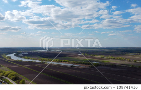 Plowed fields on the banks of the river. Aerial view. 109741416