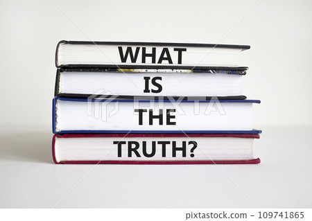 What is the truth symbol. Concept words 'What is the truth' on books on a beautiful white background. Businessman hand. Business, what is the truth concept. 109741865