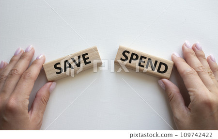 Save or Spend symbol. Concept word Save or Spend on wooden blocks. Businessman hand. Beautiful white background. Business and Save or Spend concept. Copy space 109742422