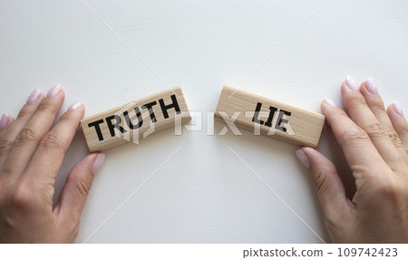 Truth or Lie symbol. Concept word Truth or Lie on wooden blocks. Businessman hand. Beautiful white background. Business and Truth or Lie concept. Copy space Truth or Lie symbol. Concept word Truth or Lie on wooden blocks. Businessman hand. Beautiful white background. Business and Truth or Lie concept. Copy space 109742423