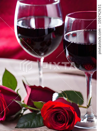 Romantic atmosphere with red wine and roses. Romantic atmosphere with red wine and roses. 109742631