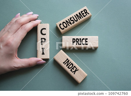 CPI - Consumer Price Index symbol. Concept word CPI on wooden blocks. Businessman hand. Beautiful grey green background. Business and CPI concept. Copy space. 109742760