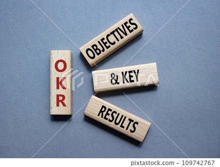 OKR objectives and key results symbol. Wooden blocks with words OKR objectives and key results. Beautiful grey background. Business and OKR concept. Copy space. OKR objectives and key results symbol. Wooden blocks with words OKR objectives and key results. Beautiful grey background. Business and OKR concept. Copy space. 109742767