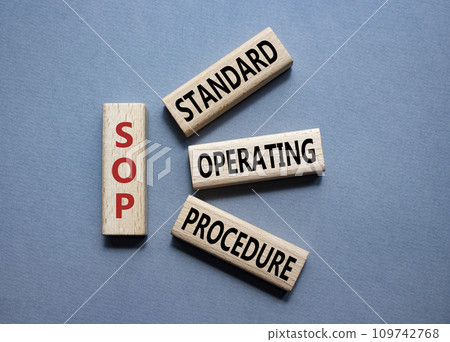 SOP - Standard Operating Procedure symbol. Wooden blocks with word SLA. Beautiful grey background. Business and Service Level Agreement concept. Copy space. 109742768