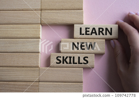 Learn new skills symbol. Concept words Learn new skills on wooden blocks. Beautiful pink background. Businessman hand. Business and Learn new skills concept. Copy space. Learn new skills symbol. Concept words Learn new skills on wooden blocks. Beautiful pink background. Businessman hand. Business and Learn new skills concept. Copy space. 109742778