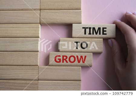 Time to Grow symbol. Concept word Time to Grow on wooden blocks. Businessman hand. Beautiful pink background. Business and Time to Grow concept. Copy space Time to Grow symbol. Concept word Time to Grow on wooden blocks. Businessman hand. Beautiful pink background. Business and Time to Grow concept. Copy space 109742779