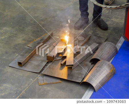 Laser cleaning of metal. Industrial removal of rust of metal surface with laser beam. Man cleaning surface from corrosion with laser metal cleaning machine. Industrial laser cleaning rust of metal. Laser cleaning of metal. Industrial removal of rust of metal surface with laser beam. Man cleaning surface from corrosion with laser metal cleaning machine. Industrial laser cleaning rust of metal. 109743083