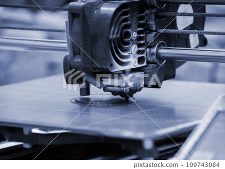 3D printer printing prototype from molten plastic. Process of creating prototype model on 3D printer from melted plastic close-up. Additive new 3D printer technology. Modern 3D printing technology. 109743084