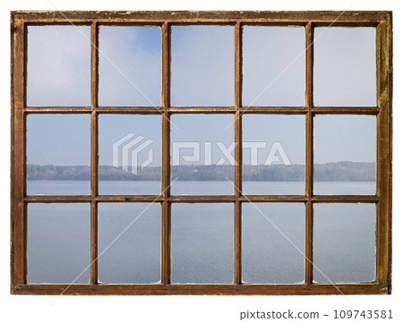 foggy morning over a lake or wide river as seen from a retro sash window foggy morning over a lake or wide river as seen from a retro sash window 109743581