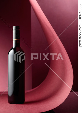 Bottle of red wine on a red background. Bottle of red wine on a red background. 109743985