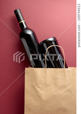 Paper shopping bag with bottles of red wine. Paper shopping bag with bottles of red wine. 109744013