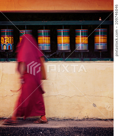 Buddhist monk spinning prayer wheels. McLeod Ganj 109746846