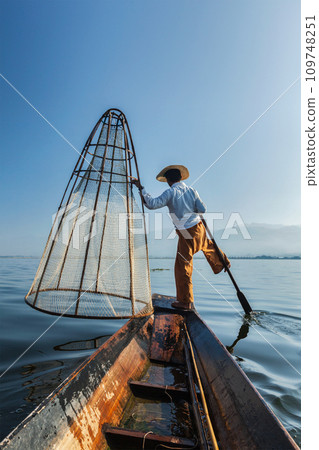 Traditional Burmese fisherman at lake, Myanmar 109748251