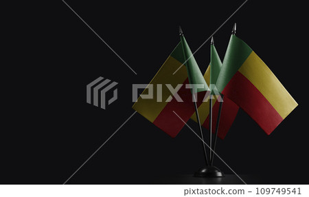 Small national flags of the Benin on a black background 109749541