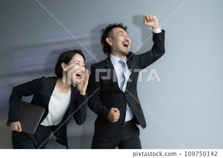 Businessman and businesswoman fist-pumping for job change and recruitment 109750142