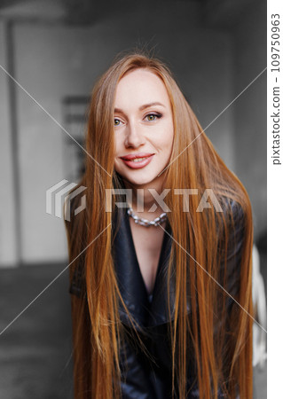 Portrait of a beautiful sexy young woman in a black leather shirt. Portrait of a beautiful sexy young woman in a black leather shirt. 109750963