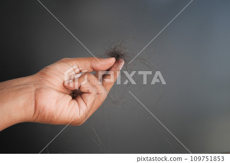 man hold his list hair against black background man hold his list hair against black background 109751853