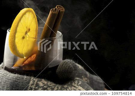 Mulled wine, red wine, gloves, holding a glass Mulled wine, red wine, gloves, holding a glass 109754814