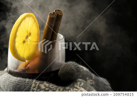 Mulled wine, red wine, gloves, holding a glass Mulled wine, red wine, gloves, holding a glass 109754815