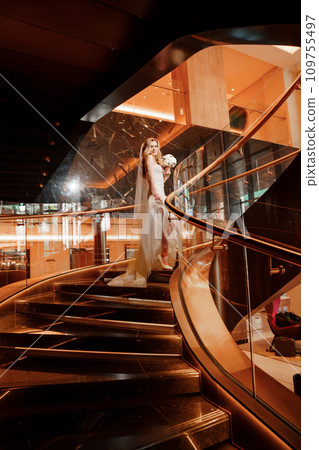 Bride on a golden spiral staircase.  109755497