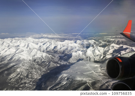 Kamchatka mountains from an airplane window and plume of ash from the eruption of Klyuchevskaya Sopka volcano. 109756835