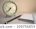 Clock, notepad and ballpoint pen 109756859