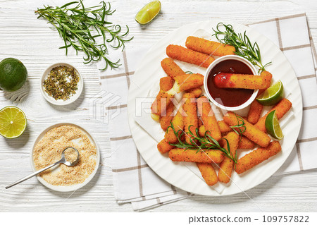 fried mozzarella sticks with sauce on white plate 109757822