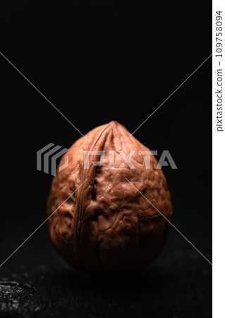 Whole walnut nut on dark wooden table 109758094