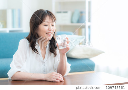 中年婦女在客廳喝水 109758561