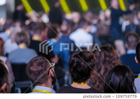 Side view of multiethnic business crowd attending global seminar at conference hall  109758779