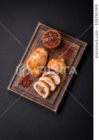 Delicious fresh meat roll made from chicken fillet, mushrooms, spices and herbs 109760369