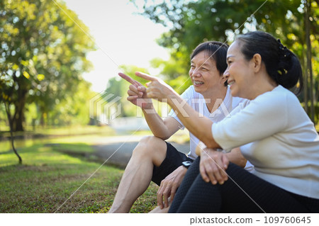 Happy old couple relaxing in the park, enjoying a beautiful day together. Happy old couple relaxing in the park, enjoying a beautiful day together. 109760645