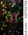 Chocolate reindeer cake with brown cream frosting decorated with antlers against colorful lights and bokeh background. Merry Christmas and Happy New Year festive concept 109760708