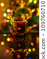 Chocolate reindeer cake with brown cream frosting decorated with antlers against colorful lights and bokeh background. Merry Christmas and Happy New Year festive concept 109760710