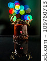 Chocolate reindeer cake with brown cream frosting decorated with antlers against colorful lights and bokeh background. Merry Christmas and Happy New Year festive concept 109760713