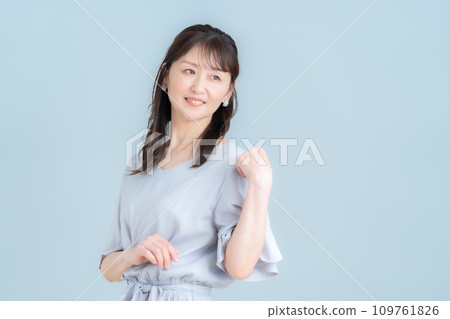 A middle-aged woman doing skin care against a gray background A middle-aged woman doing skin care against a gray background 109761826