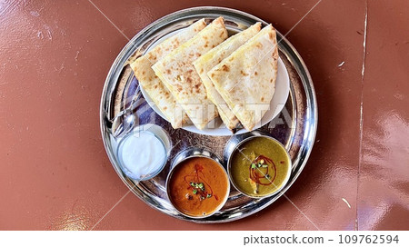 Indian-Nepalese cheese naan, rice, mixed seafood and mutton saag curry set Indian-Nepalese cheese naan, rice, mixed seafood and mutton saag curry set 109762594