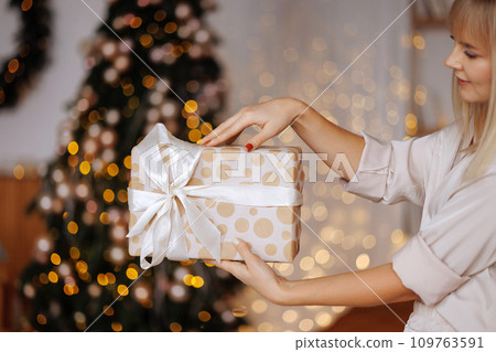 Gift in the hands of a woman for Christmas Gift in the hands of a woman for Christmas 109763591