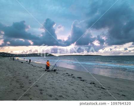 Fishing at Narin, Portnoo strand during amazing sunset in County Donegal - Ireland 109764320