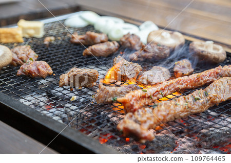 Charcoal-grilled meat grilled on a barbecue 109764465