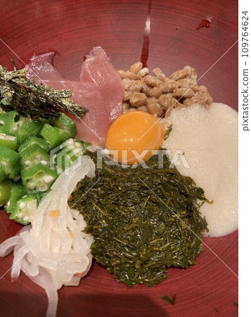 A rice bowl dish topped with gooey ingredients A rice bowl dish topped with gooey ingredients 109764624