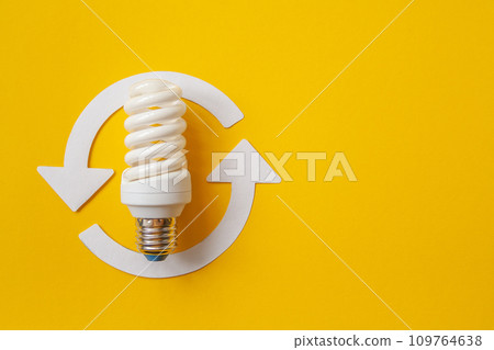 Energy saving light bulb on a orange background 109764638